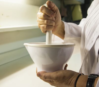 Scientist grinds up compound in porcelain mortar Scientist grinds up compound in porcelain mortar using a pestle